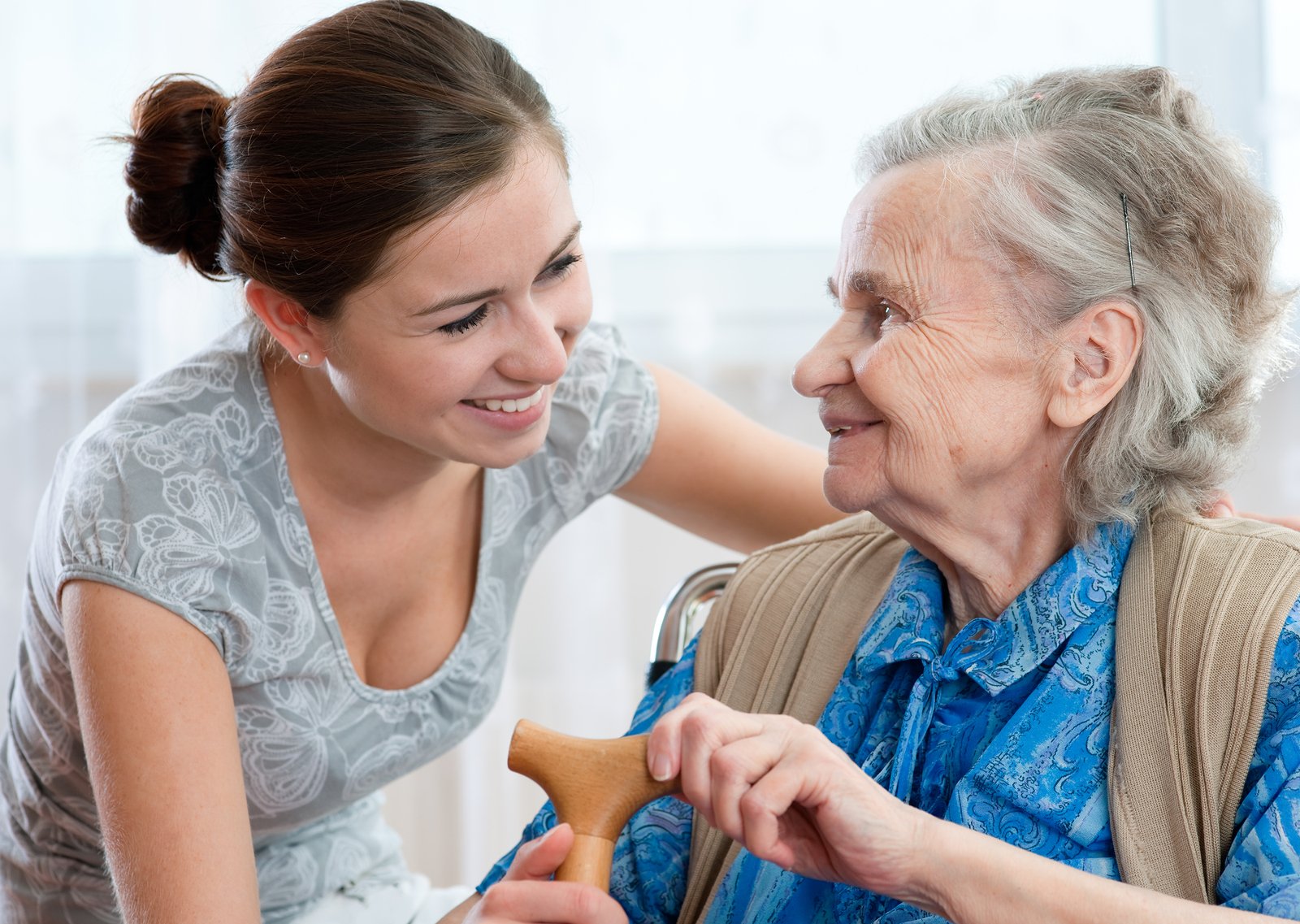 elderly female resident with female care provider