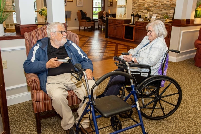 two memory care residents chatting