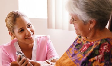 nurse assisting women at facility