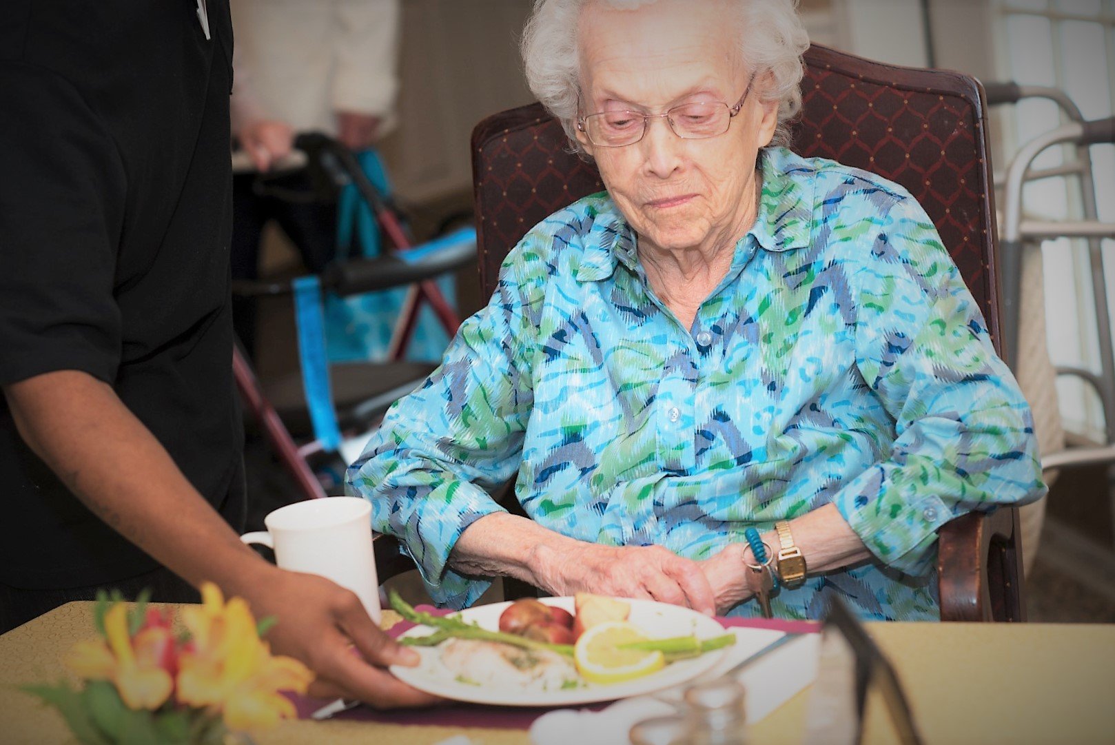 assisted living resident being served breakfast